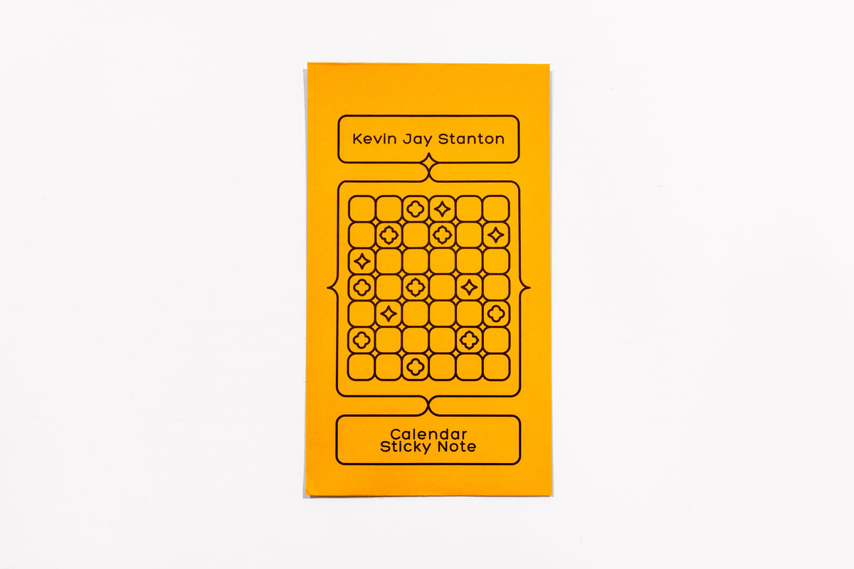 The yellow envelope packaging for the Calendar Sticky Note by Kevin Jay Stanton against a white background.
