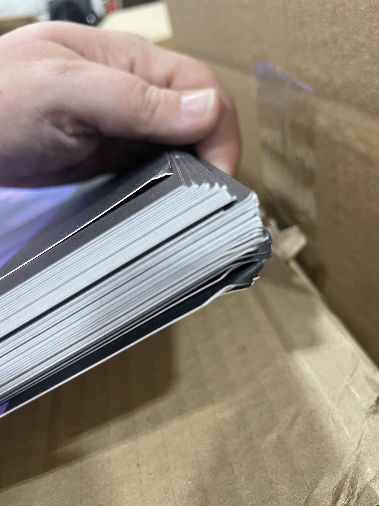 A closeup photo of the top corners of the B-Grade Rook Standard Prints. Some of the corners are folded or wrinkled, but the damage does not reach the artwork itself.