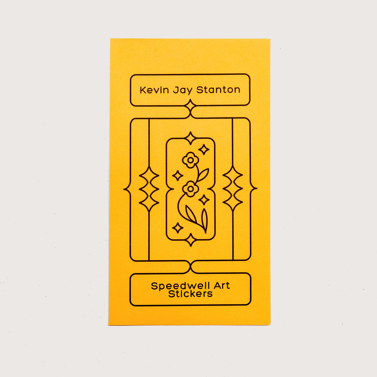 The yellow envelope packaging for the Speedwell Art Stickers by Kevin Jay Stanton against a white background.