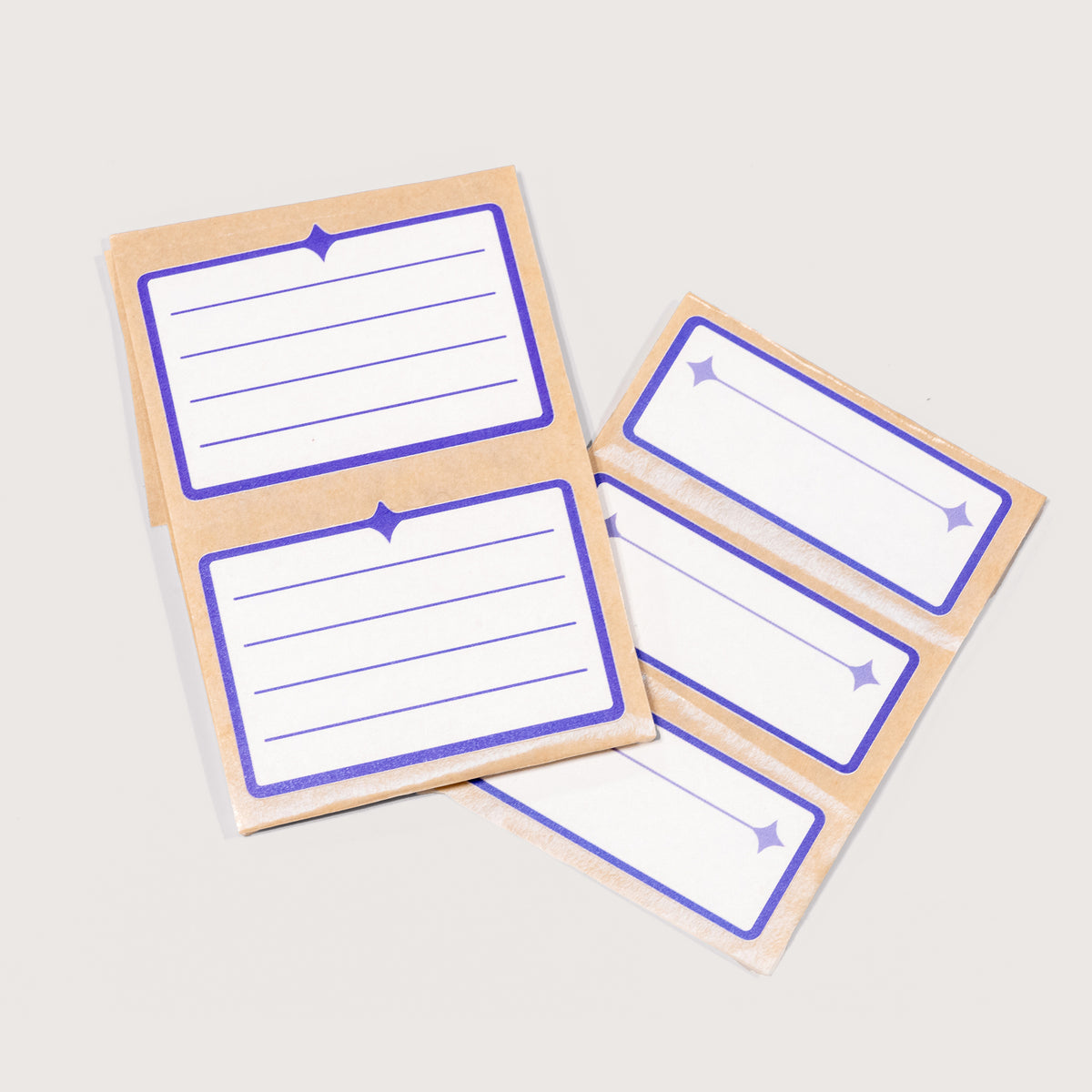 An arrangement of white and indigo Nameplate Stickers on a white background.