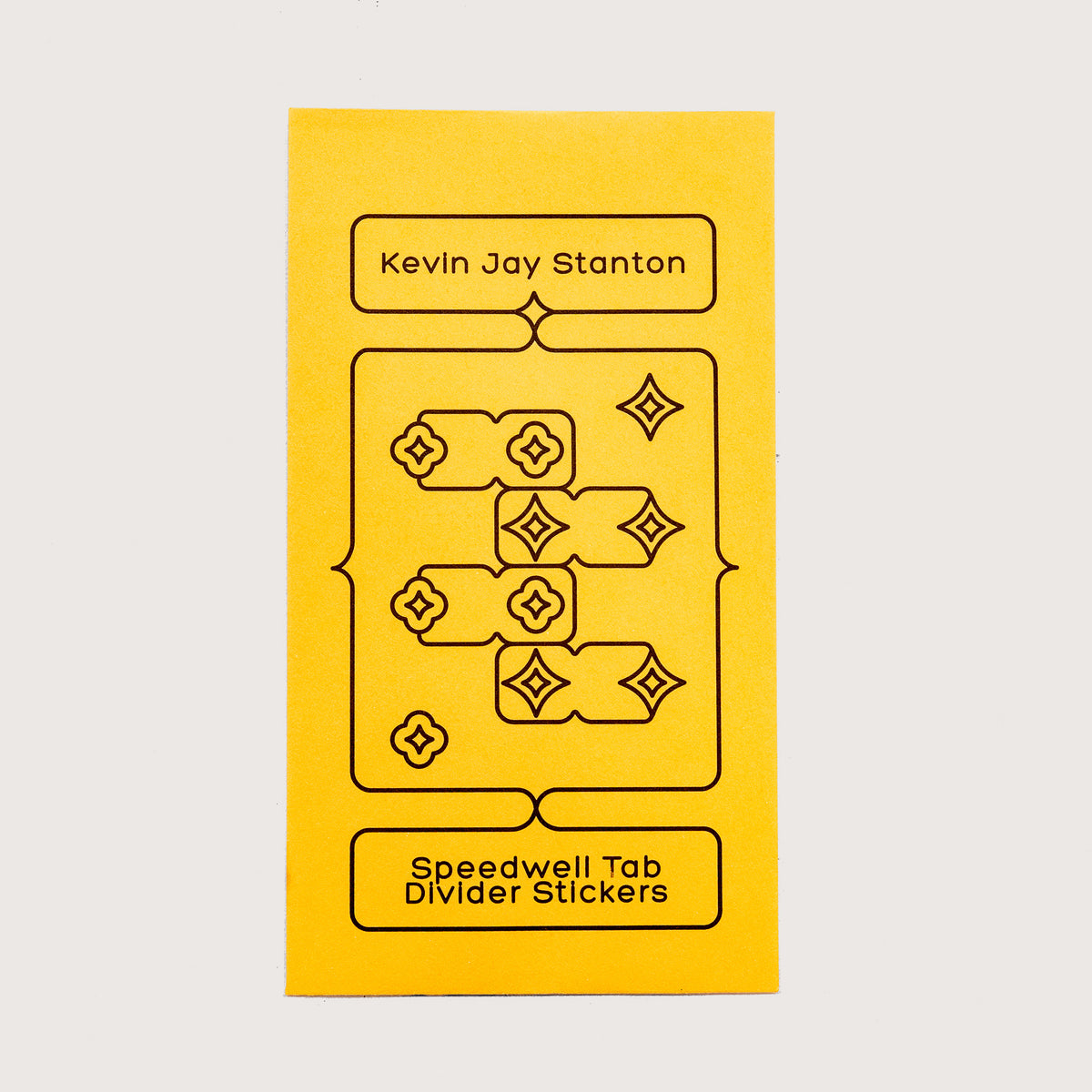 The yellow envelope packaging for the Speedwell Tab Divider Stickers by Kevin Jay Stanton against a white background.