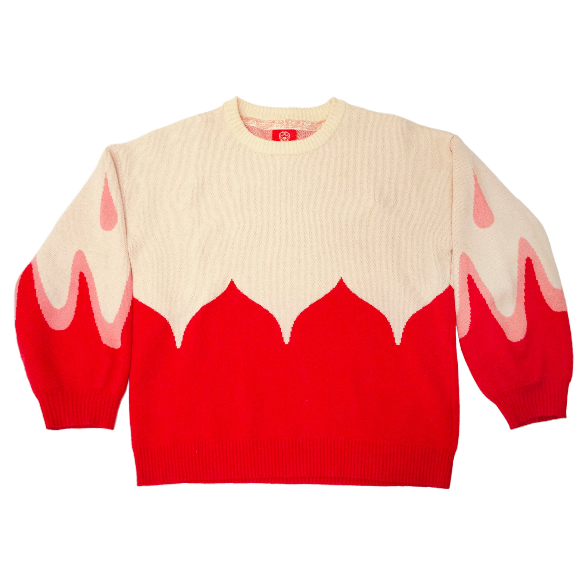 A product photo of the Sacred Blood Sweater. The cream colored top half of the sweater is bisected by the red bottom half in petal-like scalloped shapes. The shape is accentuated into the sleeves, accompanied by light pink teardrop shapes.