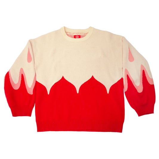 A product photo of the Sacred Blood Sweater. The cream colored top half of the sweater is bisected by the red bottom half in petal-like scalloped shapes. The shape is accentuated into the sleeves, accompanied by light pink teardrop shapes.