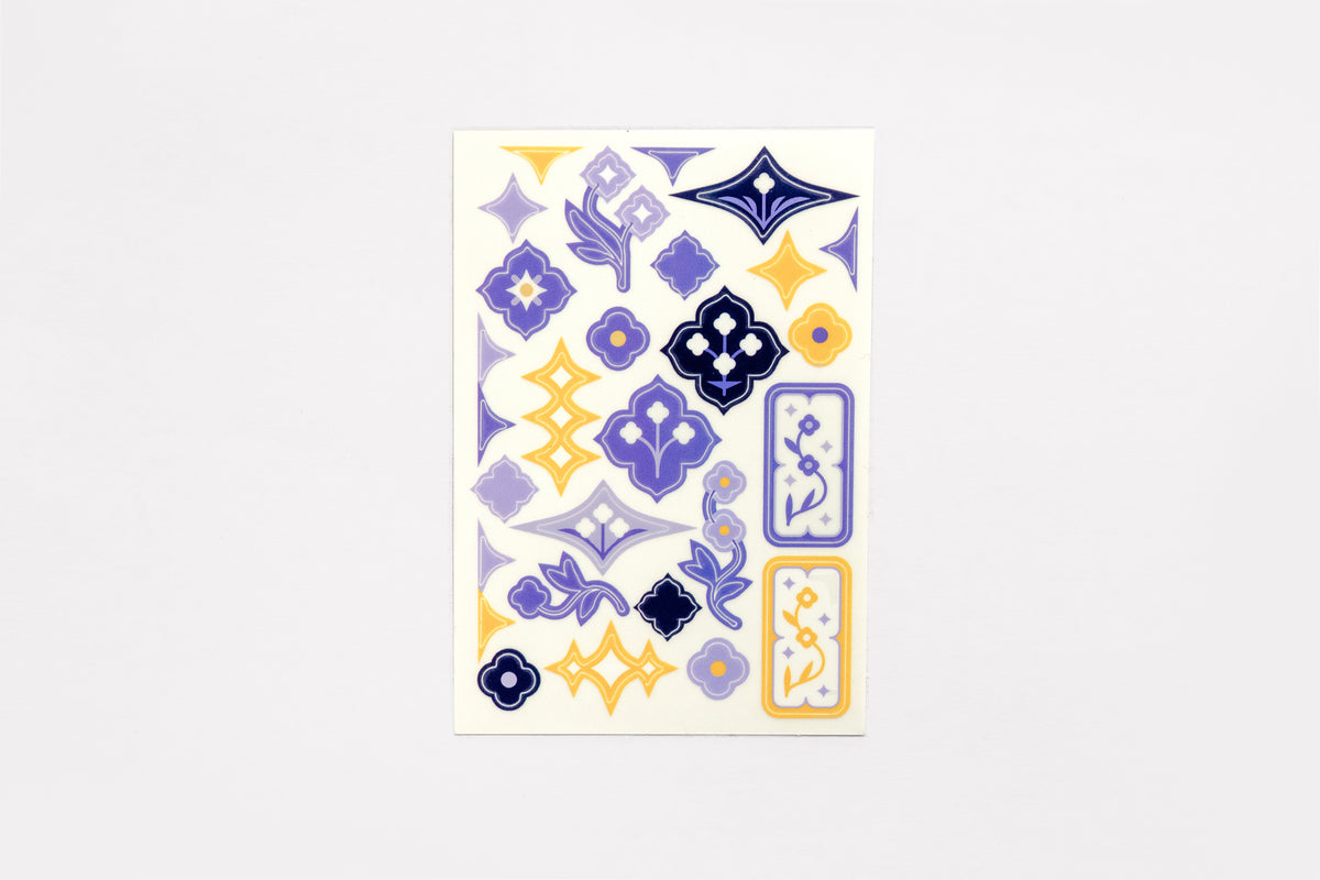 A single sheet of the Speedwell Art Stickers by Kevin Jay Stanton featuring twenty-eight miniature illustrations of Speedwell flowers in indigo, white, and yellow.
