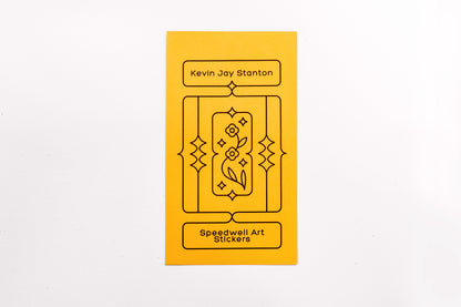 The yellow envelope packaging for the Speedwell Art Stickers by Kevin Jay Stanton against a white background.