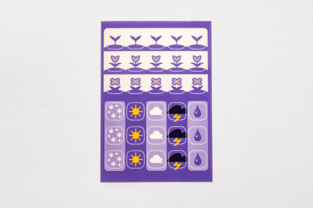 A single sheet of the Speedwell Icon Stickers by Kevin Jay Stanton featuring thirty individual stickers in indigo, white, and yellow.