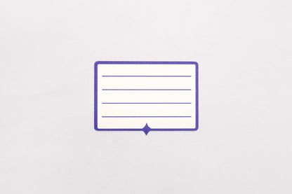 A white and indigo paper label sticker with multiple lines for written text pictured on a white background.