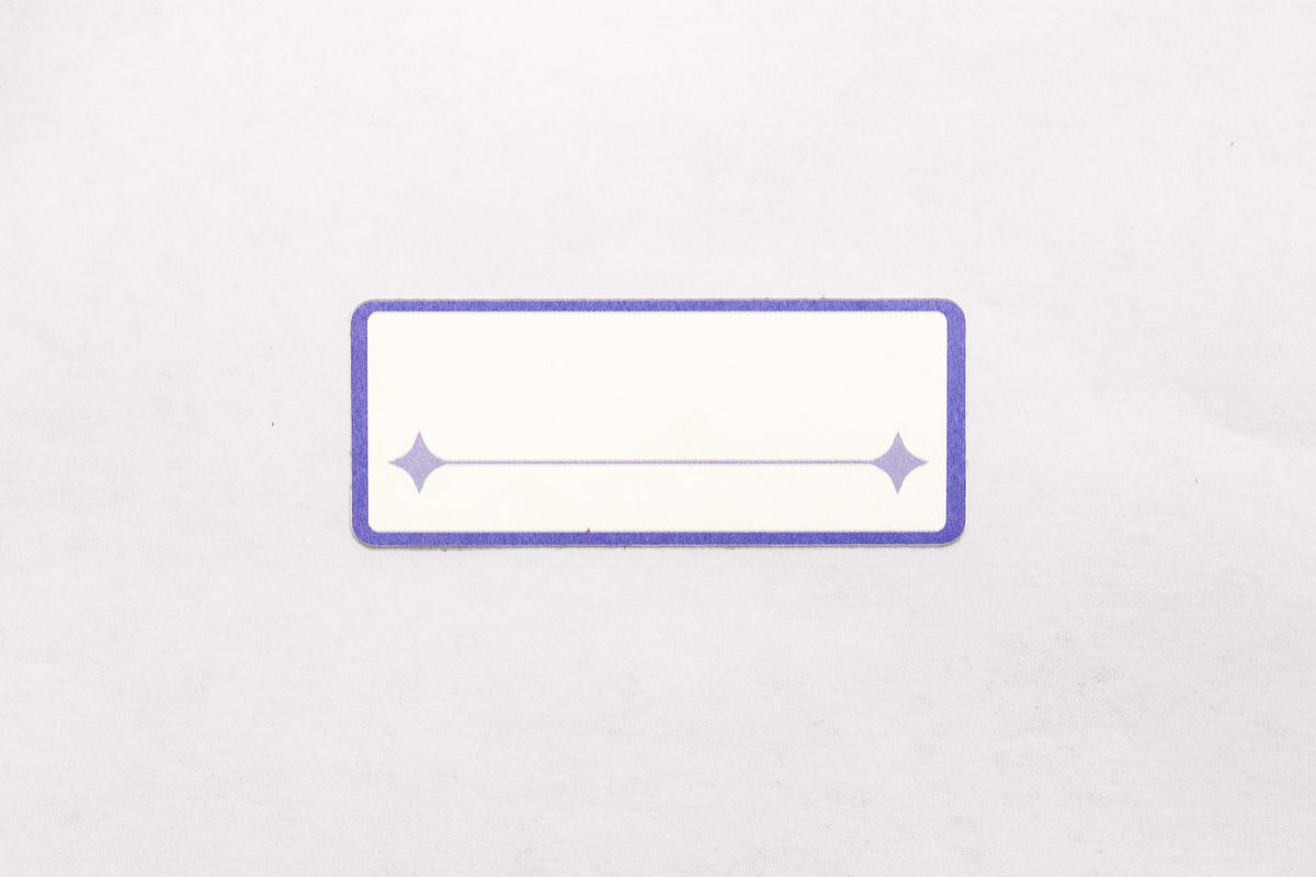 A white and indigo paper label sticker with a single line for written text pictured on a white background.
