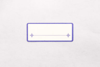 A white and indigo paper label sticker with a single line for written text pictured on a white background.
