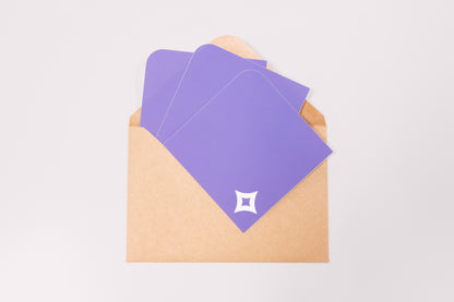 A array of Pocket Stickers with a white diamond motif photographed against a brown kraft envelope.