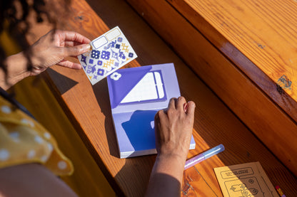 A person shows off the Speedwell Art Stickers against the Calendar Sticky Note nestled inside the pocket made from the Flower Pocket Sticker.