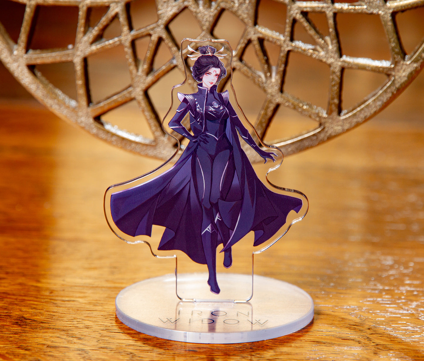 Zetian acrylic standee with warm wood and gold decoration in background.