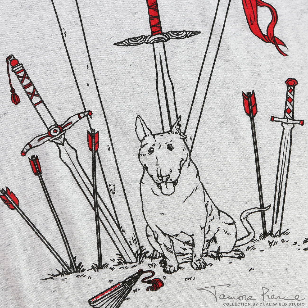Closeup of light grey t-shirt, showing black and red outlined weapons embedded in the ground around a sitting Jump the dog.